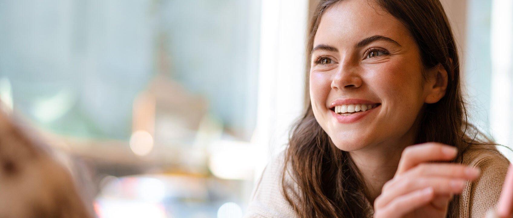 A smiling student participating in discussions, showcasing interpersonal skills and engagement during the DipHE in Therapeutic Counselling programme at University Centre Peterborough (UCP).
