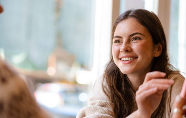 A smiling student participating in discussions, showcasing interpersonal skills and engagement during the DipHE in Therapeutic Counselling programme at University Centre Peterborough (UCP).