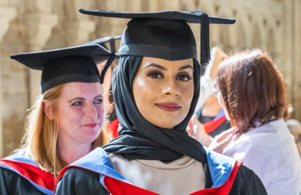 A proud graduate in academic regalia, celebrating success in the DipHE in Therapeutic Counselling programme at University Centre Peterborough (UCP).